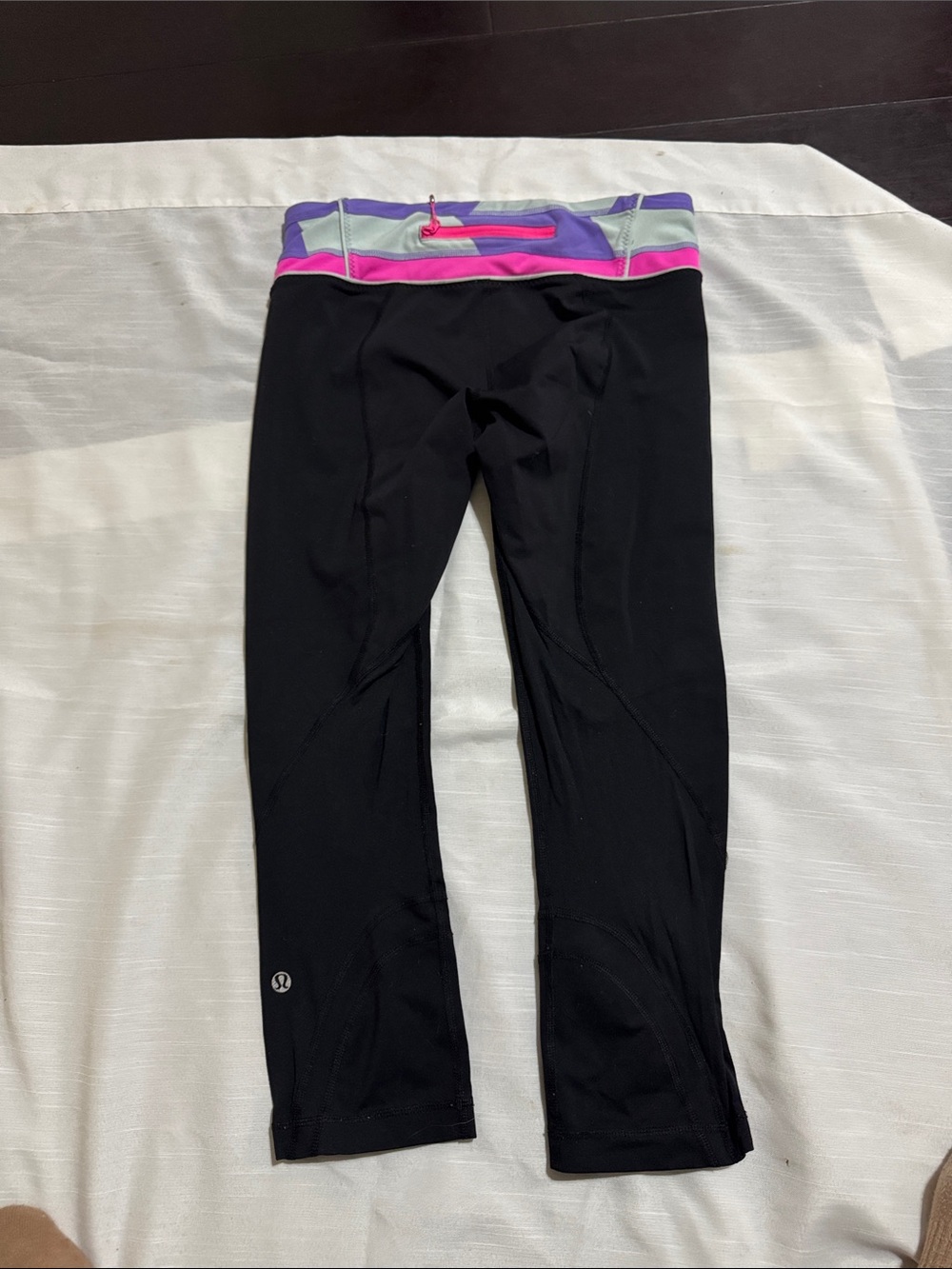 Lululemon Black capri leggings with purple, pink, and gray geometric waistband #